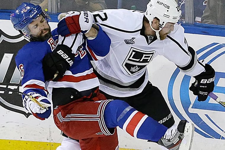 Rangers right wing Martin St. Louis collides with Kings center Trevor Lewis. (Frank Franklin II/AP)