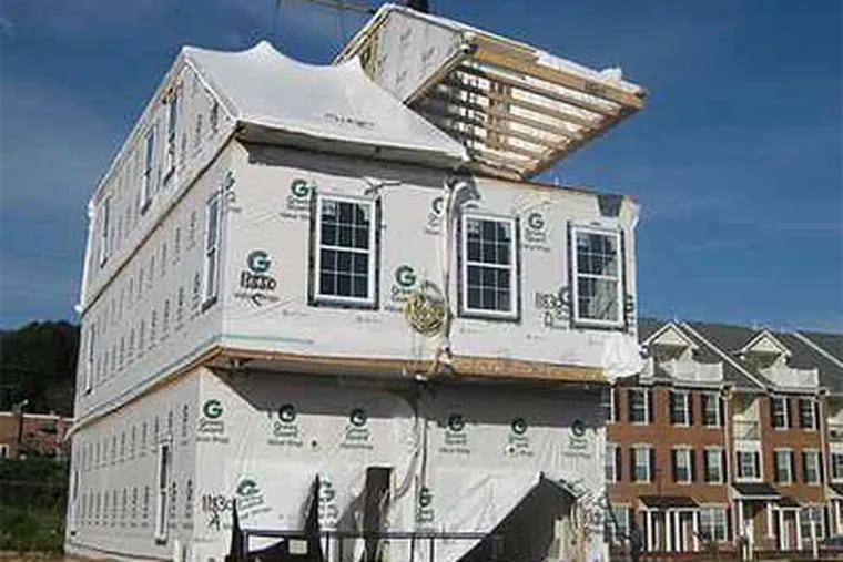The Wissahickon-Woodward townhouse model comes together at the Hilltop at Falls Ridge in the East Falls section of Philadelphia. Modulars help to lower the cost per square foot for housing construction. (Custom Building Systems)