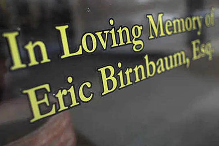 A tribute to slain attorney Eric Birnbaum (right) on the doorway to the office (above) where he worked. There's no known motive for the killing.