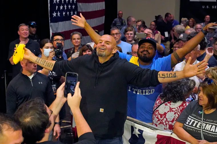 Pennsylvania Lt. Gov. John Fetterman, the Democratic nominee for U.S. Senate seat poses for a selfie with supporters after his rally in Erie.