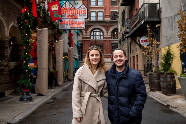 Olivia Schanz, 31, of Sharon, Pa., (left), and Jensen Galvis, 29, of Pittsburgh, Pa., (right), pose for a portrait outside of McGillin’s Olde Ale House in Philadelphia, Pa. The two, who are engaged, are residents at Temple Hospital and were out celebrating their medical fellowships on December 1st when Olivia lost her engagement ring. “I pretty much had decided that I wasn’t getting this ring back,” Schanz said.