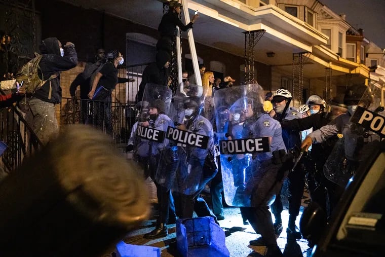 People and police clashed as people gathered in protest on the 5400 block of Pine Street,  in response to the police shooting of Walter Wallace Jr. on Monday, October 26, 2020, in Philadelphia.