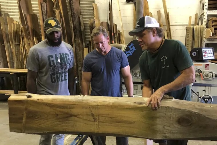Eagles safety Malcolm Jenkins works on a piece for the renovation of his parents' New Jersey backyard as part of CBS' 'Superstar Renovation.'