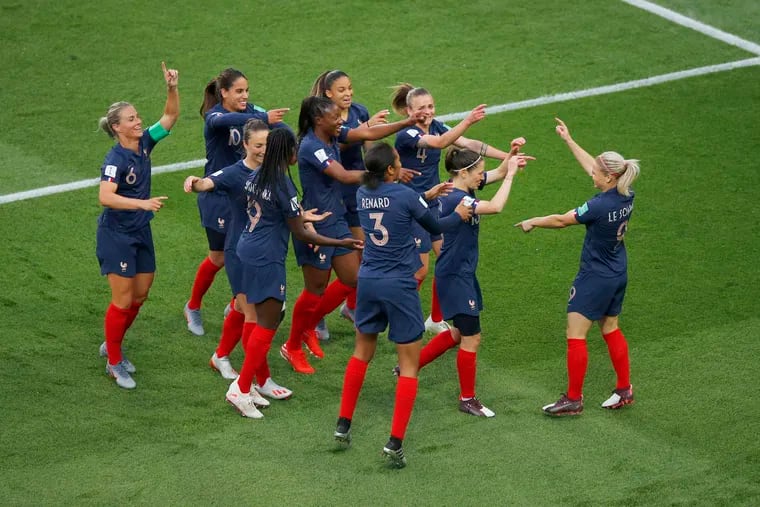 France's Eugenie Le Sommer, right, celebrates with her teammates after scoring her side's opening goal during the Women's World Cup Group A soccer match between France and South Korea, at the Parc des Princes in Paris, Friday, June 7, 2019. (AP Photo/Francois Mori)