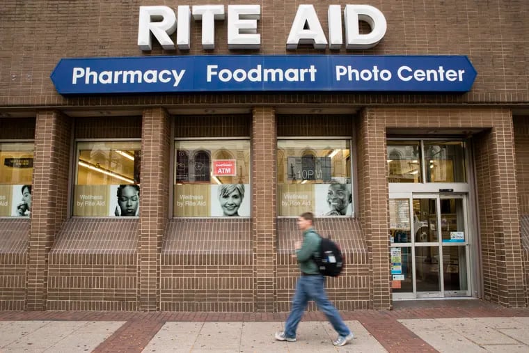 A man walks past a Rite Aid in Philadelphia.