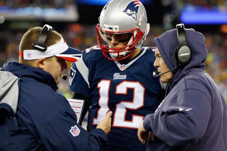 Patriots quarterback Tom Brady (12) talks with head coach Bill Belichick and offensive coordinator Josh McDaniels. (Greg M. Cooper/USA Today)