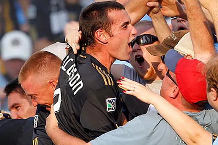 Andrew Jacobson jumped into the crowd to celebrate after the Union's win. (Yong Kim/Staff Photographer)