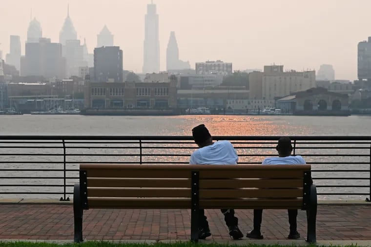 The hazy Philadelphia skyline is seen from the Camden Waterfront July 20, 2021 as smoke from the Pacific Northwest wildfires drifts into the Philadelphia region.