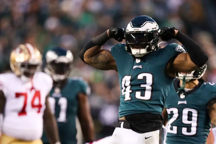 Eagles linebacker Kyzir White flexes after stopping 49ers running back Christian McCaffrey short of the first down in the third quarter of the NFC championship game.