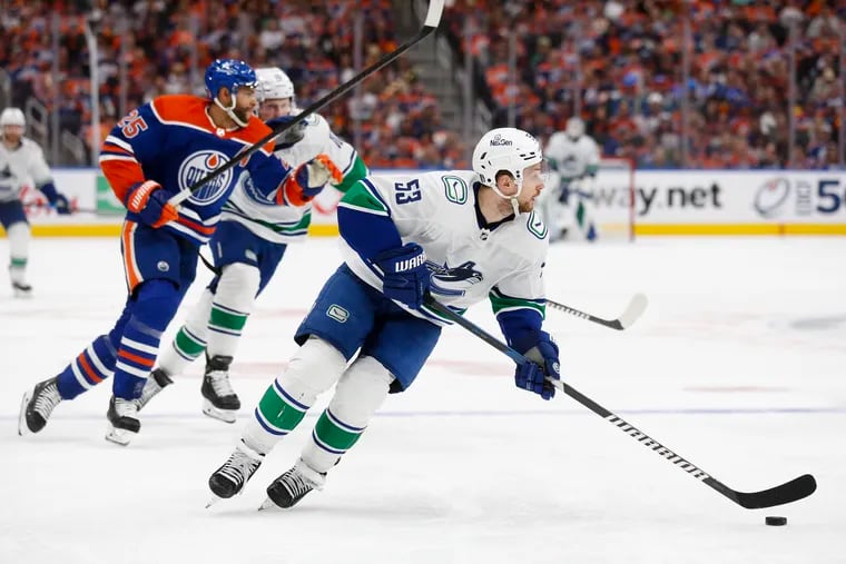 Teddy Blueger #53 of the Vancouver Canucks controls the puck during the third period against the Edmonton Oilers in Game Three of the Second Round of the 2024 Stanley Cup Playoffs at Rogers Place on May 12, 2024 in Edmonton, Alberta. (Photo by Codie McLachlan/Getty Images)