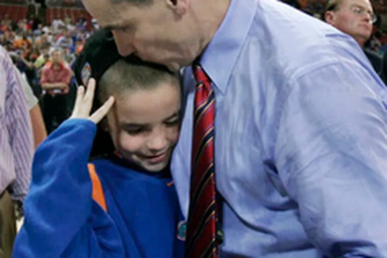 Florida coach Billy Donovan kisses son Brian after Gators beat Oregon.