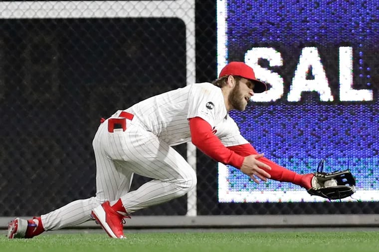Right fielder Bryce Harper makes a diving catch in the seventh inning of the Phillies' 7-4 win over the Brewers on Monday.