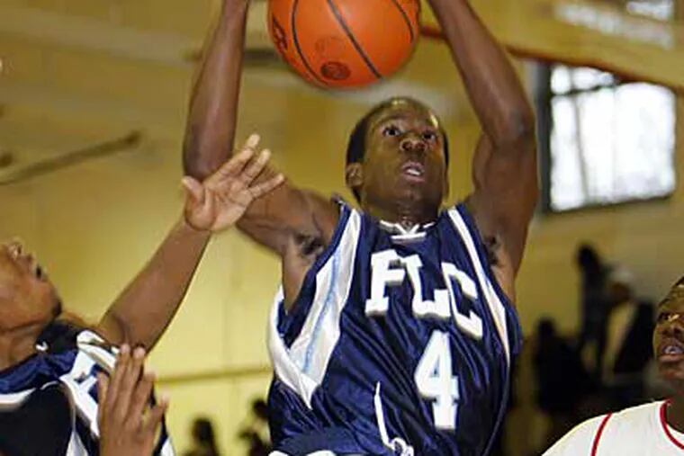 Franklin Learning Center's Denzel Yard rips down a rebound. (Yong Kim / Staff Photographer)