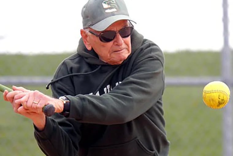 Ron Savastio, Bishop Shanahan’s 79-year-old softball coach, hits
ground balls to his players during practice. (Lou Rabito/Staff)