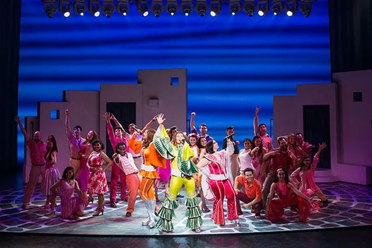 The national touring cast leans into a tune in "Mamma Mia!," kicking off its farewell tour at the Merriam Theater Dec. 27-31, 2016.