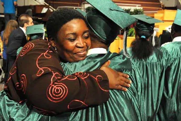 Sonya Kelly hugs her nephew Shyhiem Crump who is part of the class of 2013 of Germantown High School graduating June 19, 2013 at The Church of the New Covenant.  The school is closing next school year so the class of 2013 is the last to graduate.  ( CLEM MURRAY / Staff Photographer )