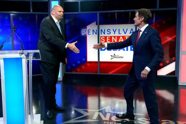 Lt. Gov. John Fetterman and Mehmet Oz shake hands prior to their Pennsylvania Senate debate.