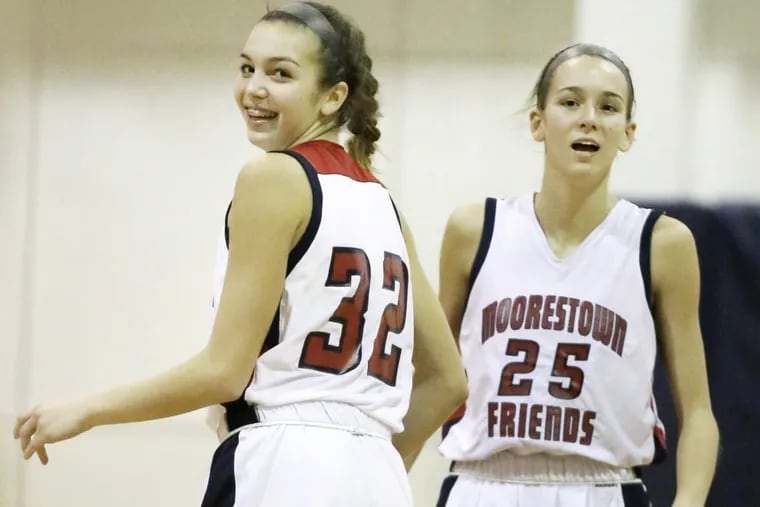 Moorestown Friends # 32 Bella Runyon and her sister # 25 Alyssa Runyon celebrate a Moorestown basket during a game, at home, against Leap Academy on January 11, 2017.