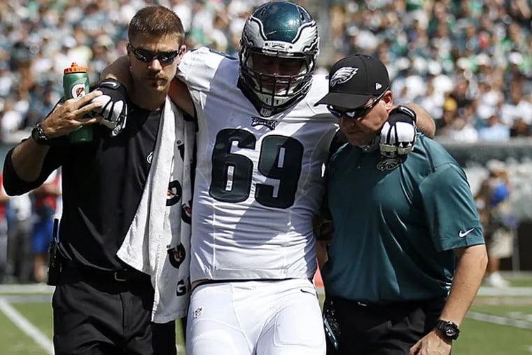 Eagles offensive lineman Evan Mathis gets helped off the field after suffering an injury against the Jaguars. (Yong Kim/Staff Photographer)