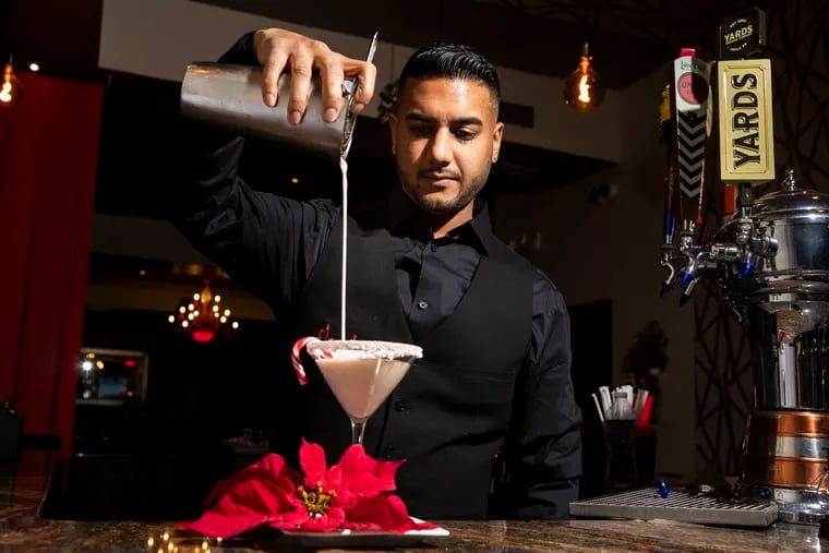 Co-owner Kevin Ramlochan pours the Flambo Crème at Flambo in Philadelphia on Monday, Dec. 19, 2022. The Flambo Crème is a festive Trinidadian take on coquito.