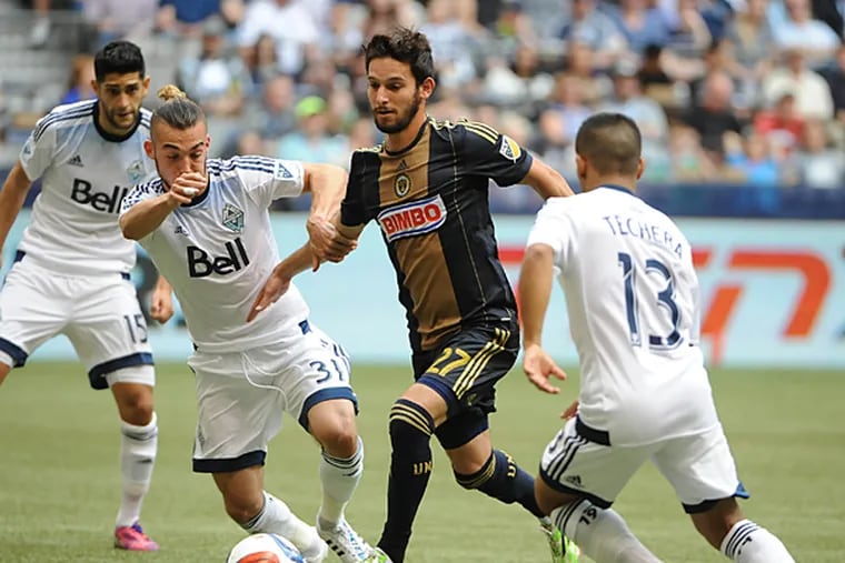 Philadelphia Union midfielder Zach Pfeffer (27) battles for the ball against Vancouver Whitecaps midfielder Russell Tiebert (31) during the second half at BC Place. The Vancouver Whitecaps won 3-0. (Anne-Marie Sorvin/USA TODAY Sports)
