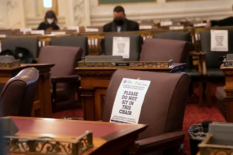 Signs that promote social distancing with regards to seating are seen in City Council Chambers on the fourth floor at City Hall in Philadelphia on Thursday, Jan. 27, 2022.
