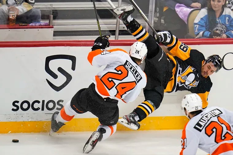 Pittsburgh's Dominik Simon is sent flying after a collision with Flyers defenseman Nick Seeler (24) during the first period.