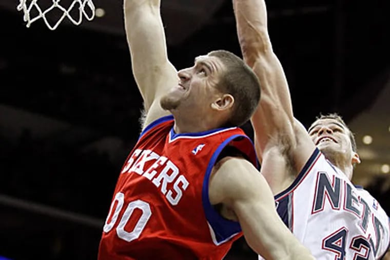 Spencer Hawes scored 19 points off the bench in the Sixers' rout of the Nets. (Julio Cortez/AP)