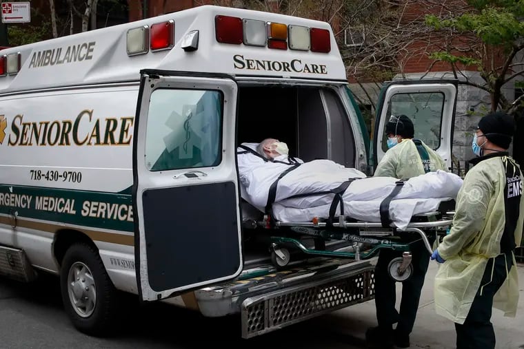 In this April 2020 photo, a patient was loaded into an ambulance by emergency medical workers outside Cobble Hill Health Center in the Brooklyn borough of New York.
