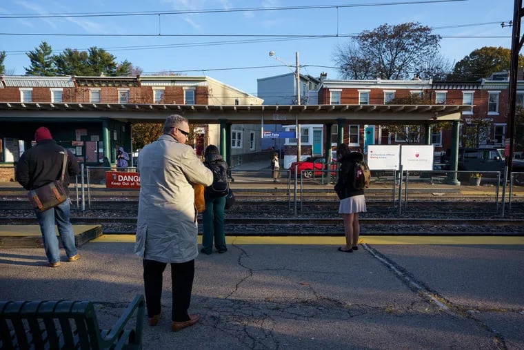 Commuters await their ride at the East Falls Regional Rail SEPTA Station.