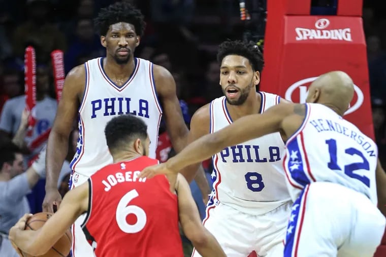 The Sixers&#039;  Joel Embiid (left), Jahlil Okafor (center) and Gerald Henderson guard the Raptors&#039; Cory Joseph during the fourth quarter at the Wells Fargo Center in Philadelphia, Wednesday, Dec. 14, 2016.