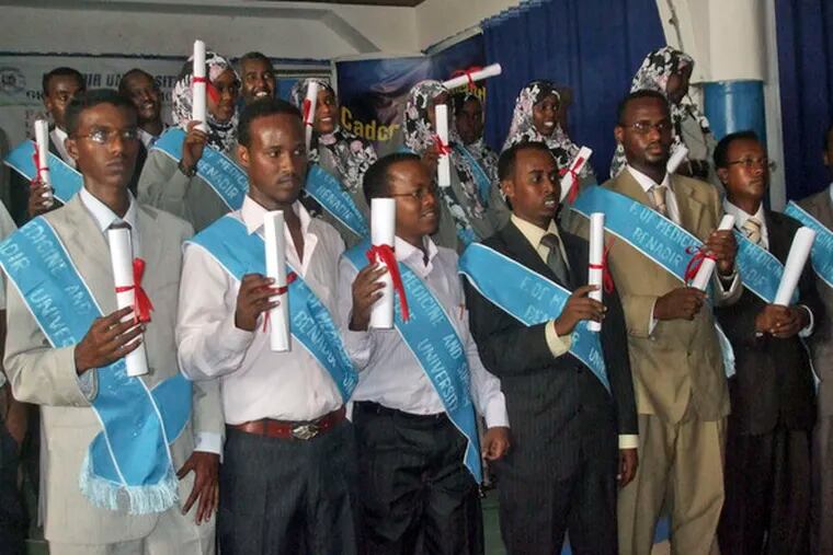 Twenty newly qualified Somali doctors hold their certificates during yesterday&#0039;s graduation ceremony in Mogadishu, Somalia. The ceremony took place inside a barricaded hotel.