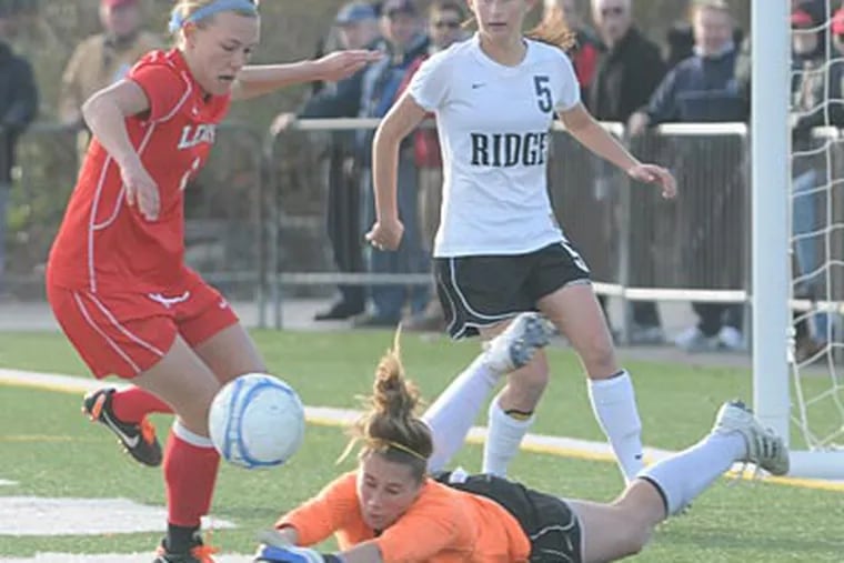 Lenape's Lizzie Kinkler chases a loose ball in front of Ridge goalkeeper Rachel Axt. (Photo: Curt Hudson)