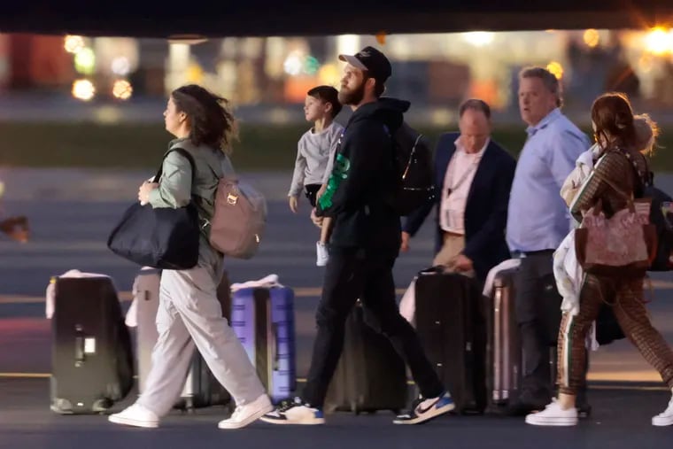 Phillies player Bryce Harper walks to the bus after landing at Philadelphia International Airport on Sunday evening.