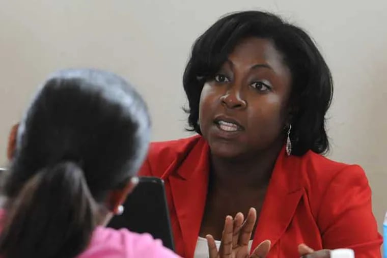 Amber Racine, 32, president of the Barristers Association of Philadelphia, explains procedures in getting a criminal record expunged to a person who attended an expungement expo at Francis Myers Rec Center in SW Philadelphia July 19, 2014.  ( CLEM MURRAY / Staff Photographer )