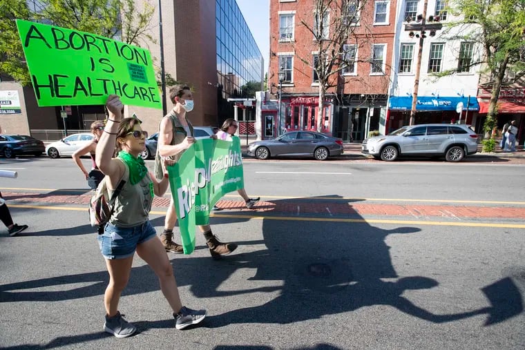 A group of approximately 25 abortion right supporters march down E. Market St. following a labor rally on Independence Mall on Aug. 20, 2022.