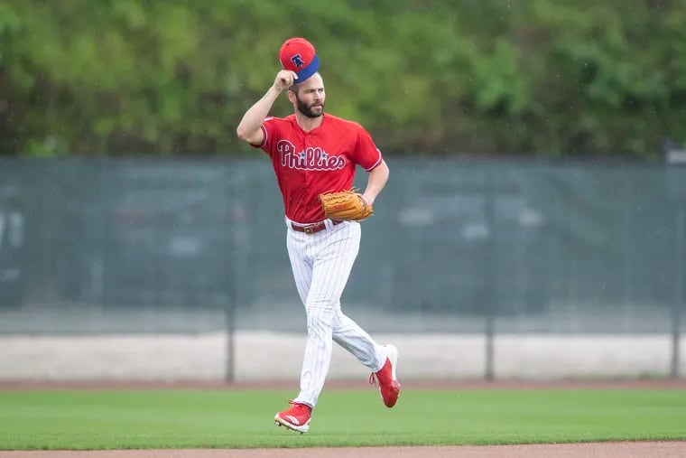 Phillies pitcher Jake Arrieta greets a fan as he runs onto the field Wednesday during spring training.
