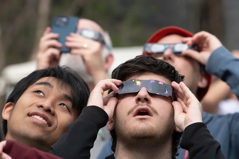 Students used solar glasses to view the sun ahead of the partial solar eclipse on Monday at Swarthmore College.