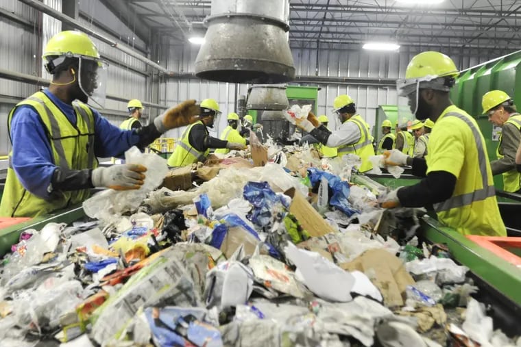 Non-recyclables are removed from items that can be recycled by workers.