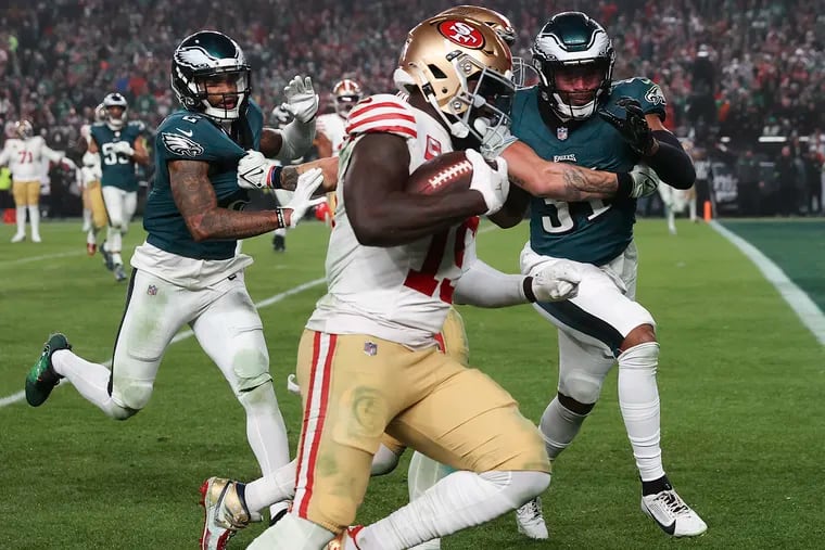 49ers wide receiver Deebo Samuel runs for a 12-yard touchdown run past Eagles safety Kevin Byard (right) and cornerback Darius Slay.