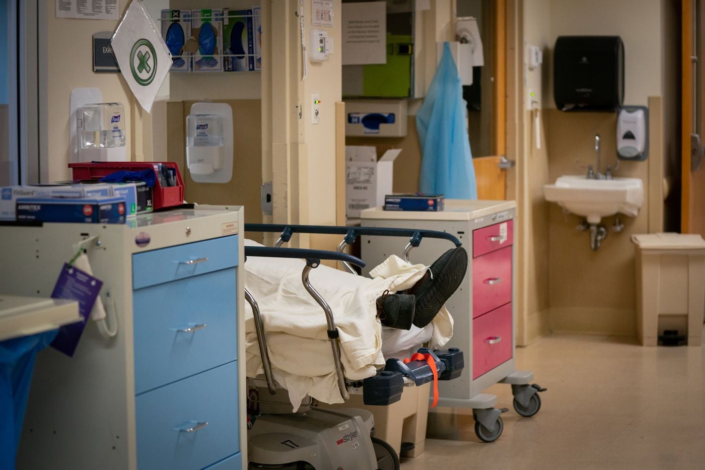 A patient with COVID-19 is wheeled into an ER bay at Suburban Community Hospital in Norristown …
