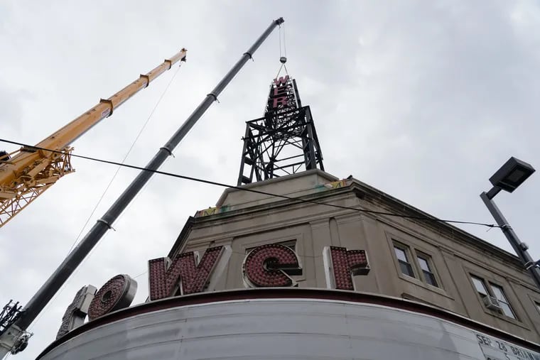 The iconic radio tower signage was being taken down at Tower Theater on Tuesday. Engineers have determined that, due to rusting, the tower is no longer safe.