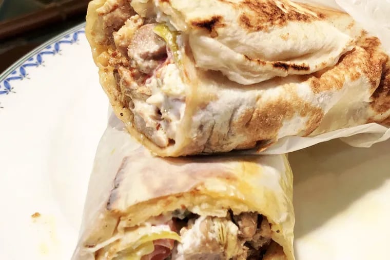The chicken shawarma at Bishos in Fox Chase is marinated with fennel and bay leaves, cooked on a vertical spit then wrapped inside saj flatbread with vegetables and sauce.