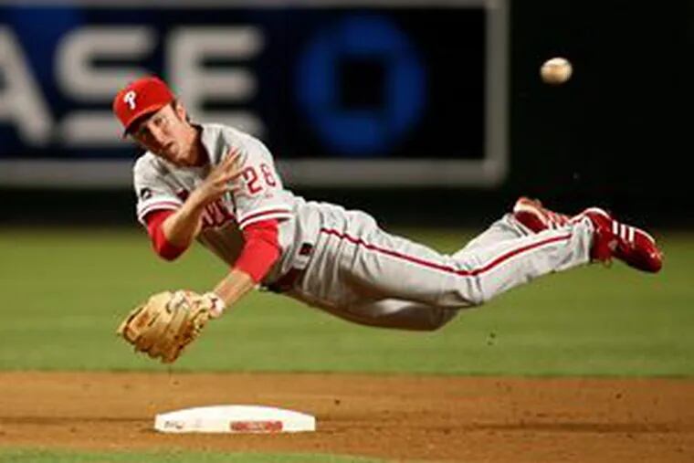 Chase Utley makes an off-balance throw to first base in the fourth inning.