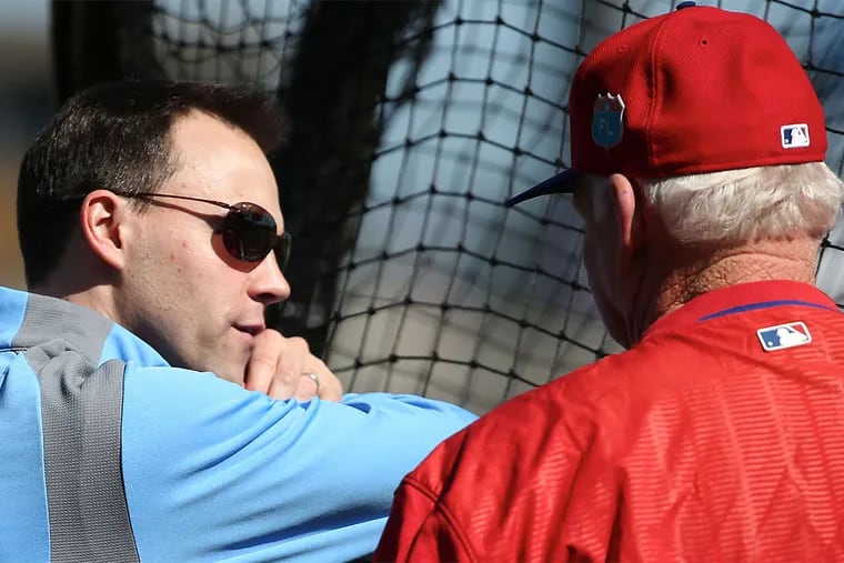 Phillies general manager Matt Klentak talks with former manager Charlie Manuel at the batting cage in Clearwater, Fla.