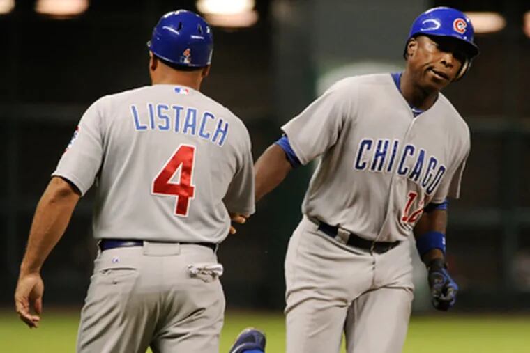 Chicago Cubs' Alfonso Soriano is congratulated by third base coach Pat Listach on a solo home run on Sep. 12. (Pat Sullivan/AP Photo)