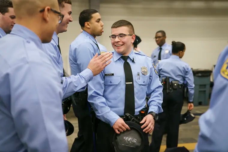 Officer Benson Churgai, center, is shown here with colleagues at the Philadelphia Police Training Center in Philadelphia. Officer Churgai is the first openly trans officer, shortly before this photo was taken Churgai had come out to his classmates in a prepared speech that received enthusiastic applause.