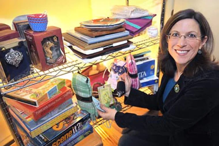 Leah Ingram of New Hope has a closet in her house with gifts she uses for re-gifting. She has more than 50 re-gifts on these shelves. (Sharon Gekoski-Kimmel / Staff Photographer)