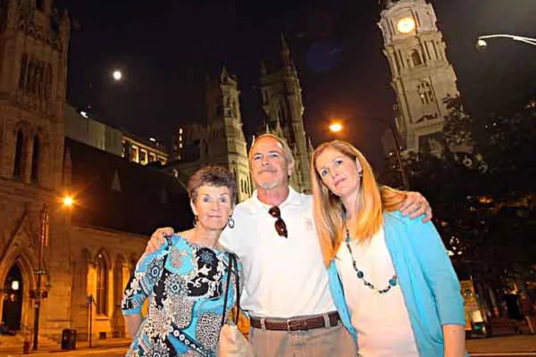 John Phelps (center) is joined by his wife, Judy Phelps (left) and daughter Erin Carmena, near North Broad and Arch Streets, the night before the three will walk to Kennett Square to raise awareness and action around gun control and the safety of children on Wednesday, May 22, 2013. John Phelps is the founder of Gun Control Today and has been walking from Sandy Hook, CT. through Philadelphia and ending in Washington, D.C.   ( Yong Kim / Staff Photographer )