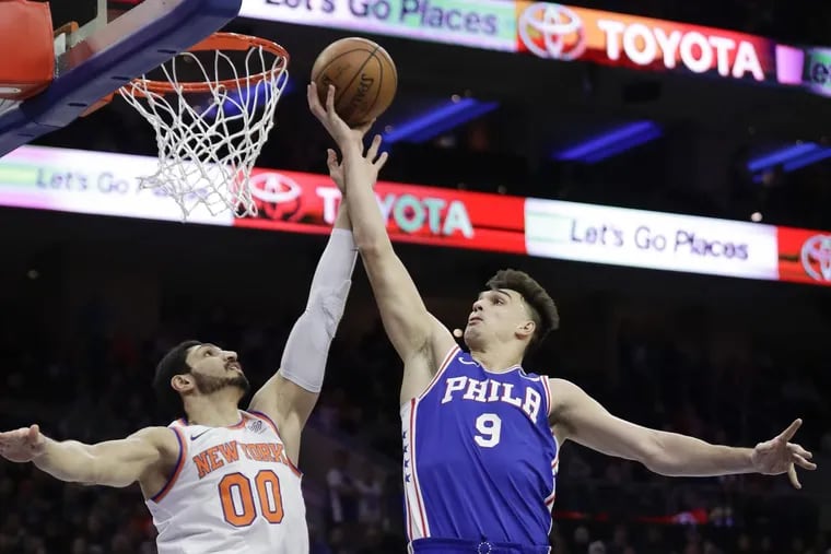 Dario Saric gets fouled attempting a layup against New York’s Enes Kanter during the first-quarter of the Sixers’ 108-92 win over the Knicks Monday.